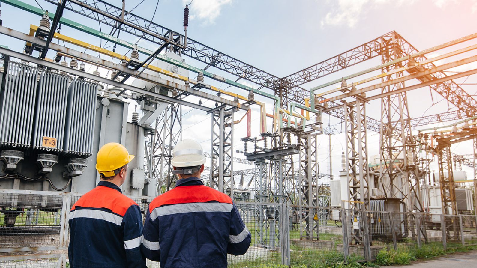 Electricians in front of a substation